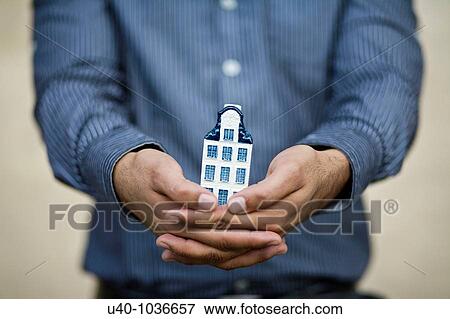 Stock Photo - hands holding new home. Fotosearch