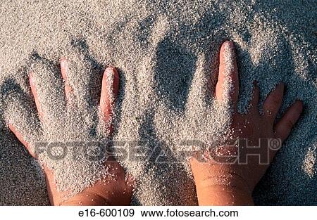 Stock Photo - Hands in sand. Fotosearch