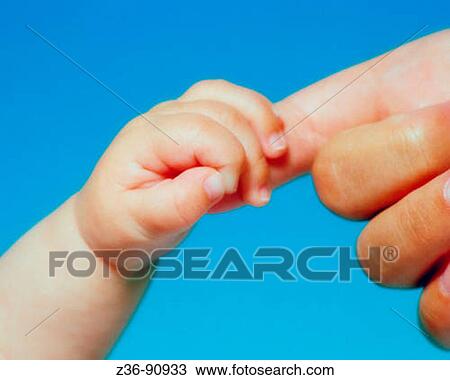 Stock Image - Hands of mother and baby. Fotosearch