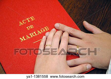 Hands of newlyweds brides over the wedding official act book at end of civil celebration by the mayor in town hall, France View Large Photo Image Stock Photo - Hands of newlyweds brides over the wedding official act book at end of civil celebration by the mayor in town hall, France. Fotosearch