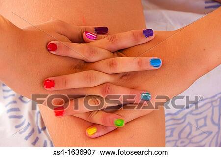 Hands of young girl with colors nails View Large Photo Image Stock Photo - Hands of young girl with colors nails. Fotosearch