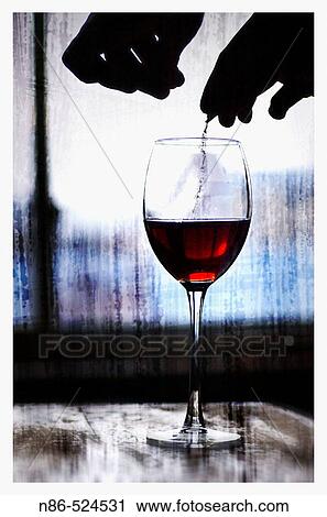 Hands placing powder in a wine glass View Large Photo Image Stock Image - Hands placing powder in a wine glass. Fotosearch