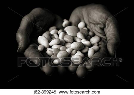 Hands that offer white stones, polished Means the whisper of water Conceptual Black and white View Large Photo Image Stock Photography - Hands that offer white stones, polished Means the whisper of water Conceptual Black and white. Fotosearch