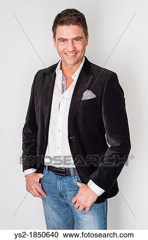 Stock Image - Handsome adult male looking relaxed and happy. Fotosearch