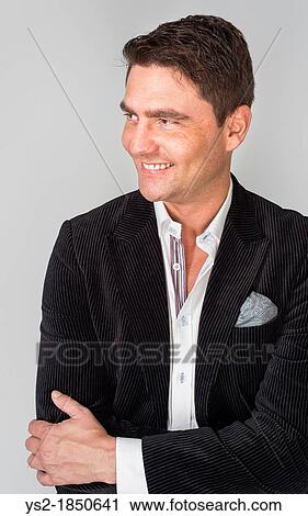 Handsome adult male looking relaxed and happy View Large Photo Image Stock Image - Handsome adult male looking relaxed and happy. Fotosearch