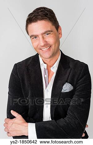 Handsome adult male looking relaxed and happy View Large Photo Image Stock Image - Handsome adult male looking relaxed and happy. Fotosearch