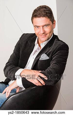 Handsome adult male looking relaxed and happy View Large Photo Image Stock Image - Handsome adult male looking relaxed and happy. Fotosearch