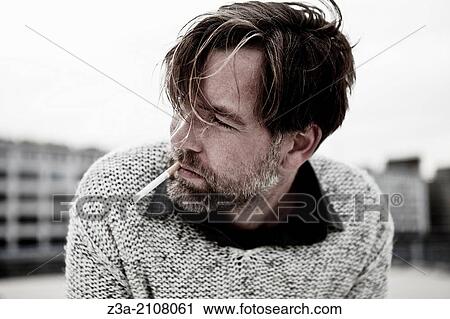 Stock Image - Handsome Man Smoking Cigarette. Fotosearch