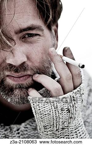 Stock Image - Handsome Man Smoking Cigarette. Fotosearch