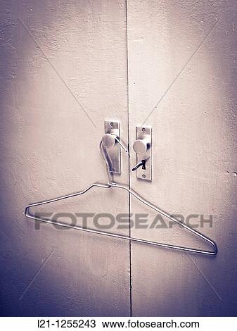 Hanger at the doors of a wardrobe View Large Photo Image Stock Image - Hanger at the doors of a wardrobe. Fotosearch