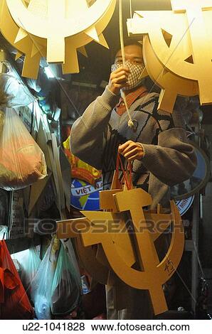Hanoi (Vietnam): a man displaying Communist symbols for sale in a shop View Large Photo Image Stock Photo - Hanoi (Vietnam): a man displaying Communist symbols for sale in a shop. Fotosearch