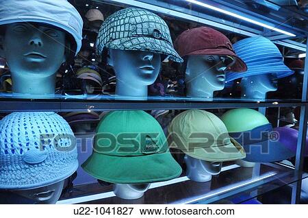 Stock Photo - Hanoi (Vietnam): fancy helmets for motor-bikes drivers sold in a shop. Fotosearch