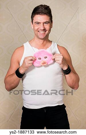 Happy adult male with pig mask smiling and looking at camera View Large Photo Image Stock Image - Happy adult male with pig mask smiling and looking at camera. Fotosearch