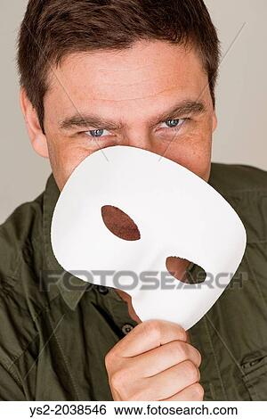 Happy and smiling man hiding behind white mask. View Large Photo Image Stock Photograph - Happy and smiling man hiding behind white mask.. Fotosearch