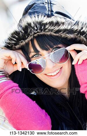 Happy and warm under the hood young woman View Large Photo Image Stock Image - Happy and warm under the hood young woman. Fotosearch