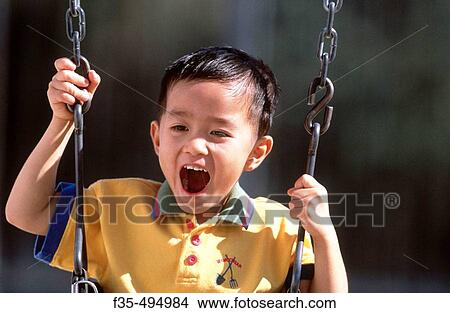 Happy Asian boy Having Fun on a Swing View Large Photo Image Picture - Happy Asian boy Having Fun on a Swing. Fotosearch