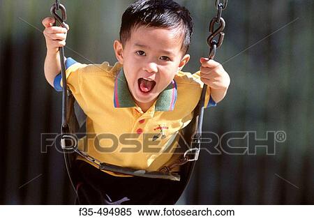 Happy Asian boy on a Swing View Large Photo Image Stock Photography - Happy Asian boy on a Swing. Fotosearch