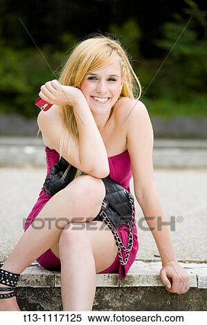 Happy attractive young woman with a cellular phone in hand View Large Photo Image Stock Photography - Happy attractive young woman with a cellular phone in hand. Fotosearch