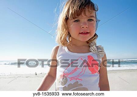 Stock Image - Happy baby girl at the beach. Fotosearch