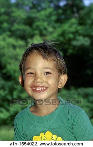 Stock Image - Happy Boy: Afghan-American boy, 3-5 years old, with a wide smile in summertime. Midwest, USA. Fotosearch