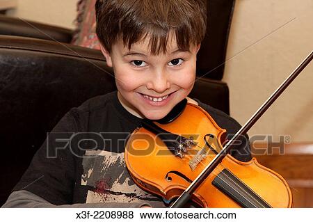 Happy boy age 8 playing violin in his home. St Paul Minnesota MN USA. View Large Photo Image Stock Photo - Happy boy age 8 playing violin in his home. St Paul Minnesota MN USA.. Fotosearch