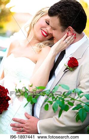 happy bride and groom embrace after their wedding in a rose garden View Large Photo Image Stock Image - happy bride and groom embrace after their wedding in a rose garden. Fotosearch