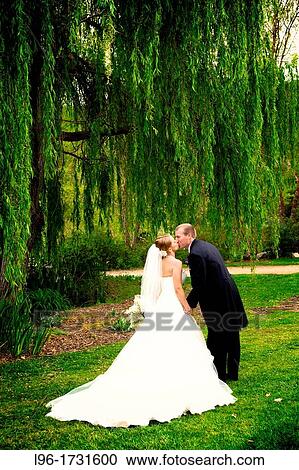 happy bride and groom kissing after garden wedding View Large Photo Image Stock Image - happy bride and groom kissing after garden wedding. Fotosearch