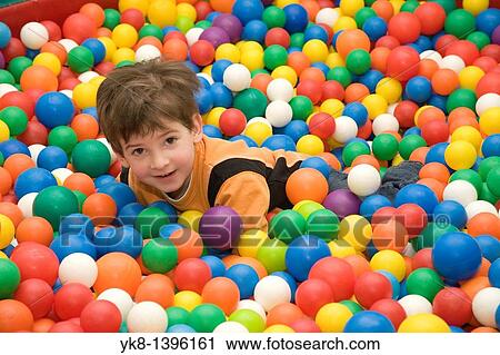 Happy Caucasian Kid Boy in Playground with Colorful Toy Balls View Large Photo Image Stock Image - Happy Caucasian Kid Boy in Playground with Colorful Toy Balls. Fotosearch