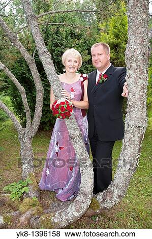 Happy Caucasian Wedding Couple by Pine Tree Trunk View Large Photo Image Stock Photo - Happy Caucasian Wedding Couple by Pine Tree Trunk. Fotosearch