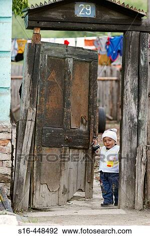 Happy child opening the gate of his yard - Tigmandru village, Mures County, Transylvania, Romania View Large Photo Image Stock Image - Happy child opening the gate of his yard - Tigmandru village, Mures County, Transylvania, Romania. Fotosearch