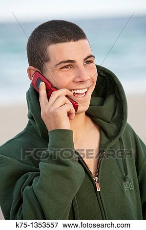 Happy conversation on cell phone at the beach View Large Photo Image Stock Photo - Happy conversation on cell phone at the beach. Fotosearch