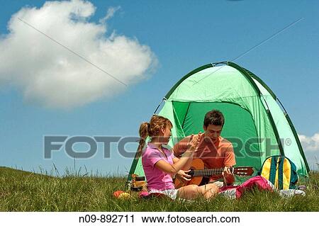 Stock Image - Happy Couple Camping. Fotosearch