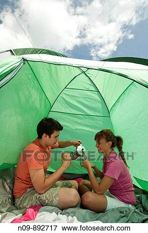 Stock Photo - Happy Couple Camping. Fotosearch