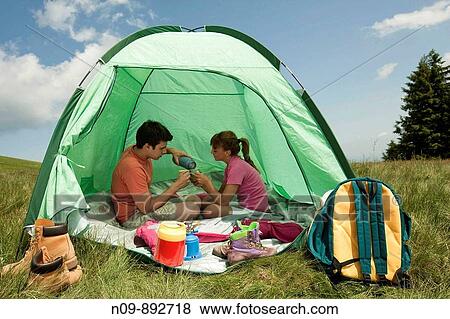 Stock Photo - Happy Couple Camping. Fotosearch