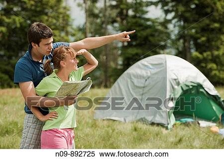 Stock Photography - Happy Couple Camping. Fotosearch