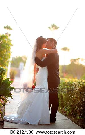 happy couple embracing, kissing in a garden View Large Photo Image Stock Image - happy couple embracing, kissing in a garden. Fotosearch