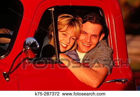 Happy couple in red pick-up truck View Large Photo Image Stock Image - Happy couple in red pick-up truck. Fotosearch