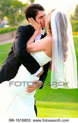 happy couple just married kissing and embracing after wedding View Large Photo Image Stock Image - happy couple just married kissing and embracing after wedding. Fotosearch