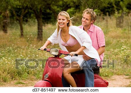 Happy couple on a scooter in the country View Large Photo Image Stock Photo - Happy couple on a scooter in the country. Fotosearch