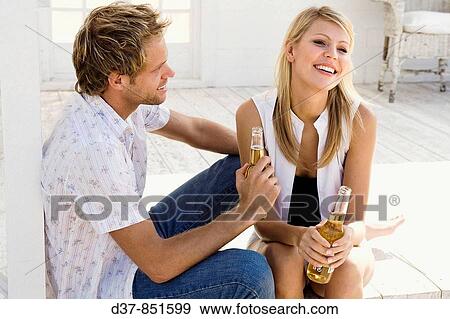 Happy couple talking and chilling out View Large Photo Image Stock Photo - Happy couple talking and chilling out. Fotosearch
