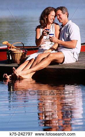 Stock Photo - happy couple toasting together. Fotosearch