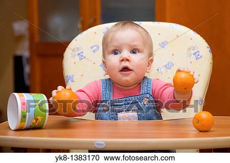 Happy Eight Month Old Infant Girl with Oranges in High Chair View Large Photo Image Stock Image - Happy Eight Month Old Infant Girl with Oranges in High Chair. Fotosearch