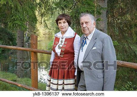 Happy Elderly Senior Couple Standing by Wooden Fence View Large Photo Image Stock Photo - Happy Elderly Senior Couple Standing by Wooden Fence. Fotosearch