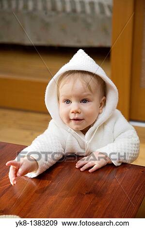 Happy Emotional Ten Month Old Haby Girl Pointing Hand, Woolly Hood on Head View Large Photo Image Stock Photo - Happy Emotional Ten Month Old Haby Girl Pointing Hand, Woolly Hood on Head. Fotosearch