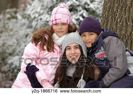 Stock Photograph - Happy family Posing for a Portrait in the Park. Fotosearch