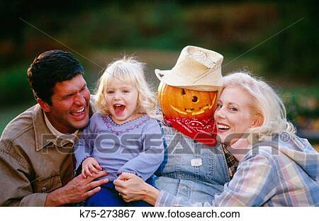 Happy family with pumpkin View Large Photo Image Stock Photo - Happy family with pumpkin. Fotosearch