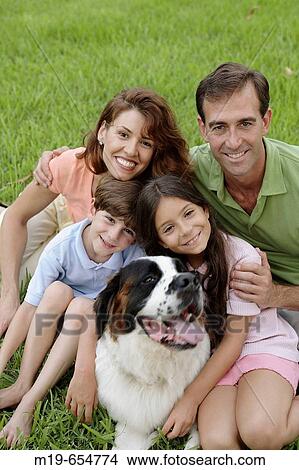 Happy family with their pet dog View Large Photo Image Picture - Happy family with their pet dog. Fotosearch