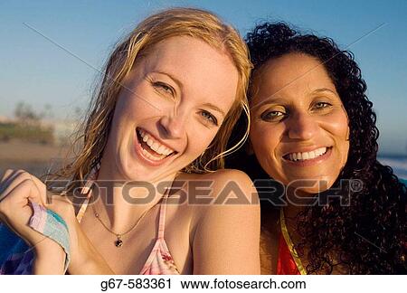 Happy girl friends at beach in California, USA at sunset View Large Photo Image Stock Image - Happy girl friends at beach in California, USA at sunset. Fotosearch