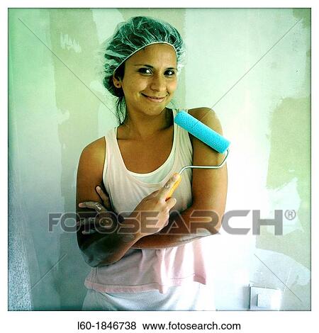 Stock Photo - Happy girl painting in her new home. Fotosearch