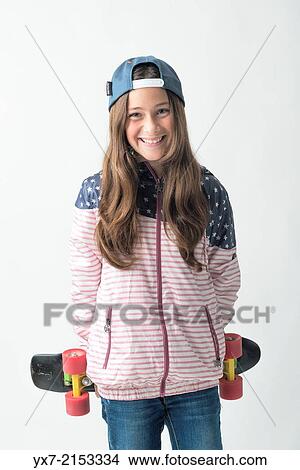 Happy girl with a skateboard View Large Photo Image Picture - Happy girl with a skateboard. Fotosearch